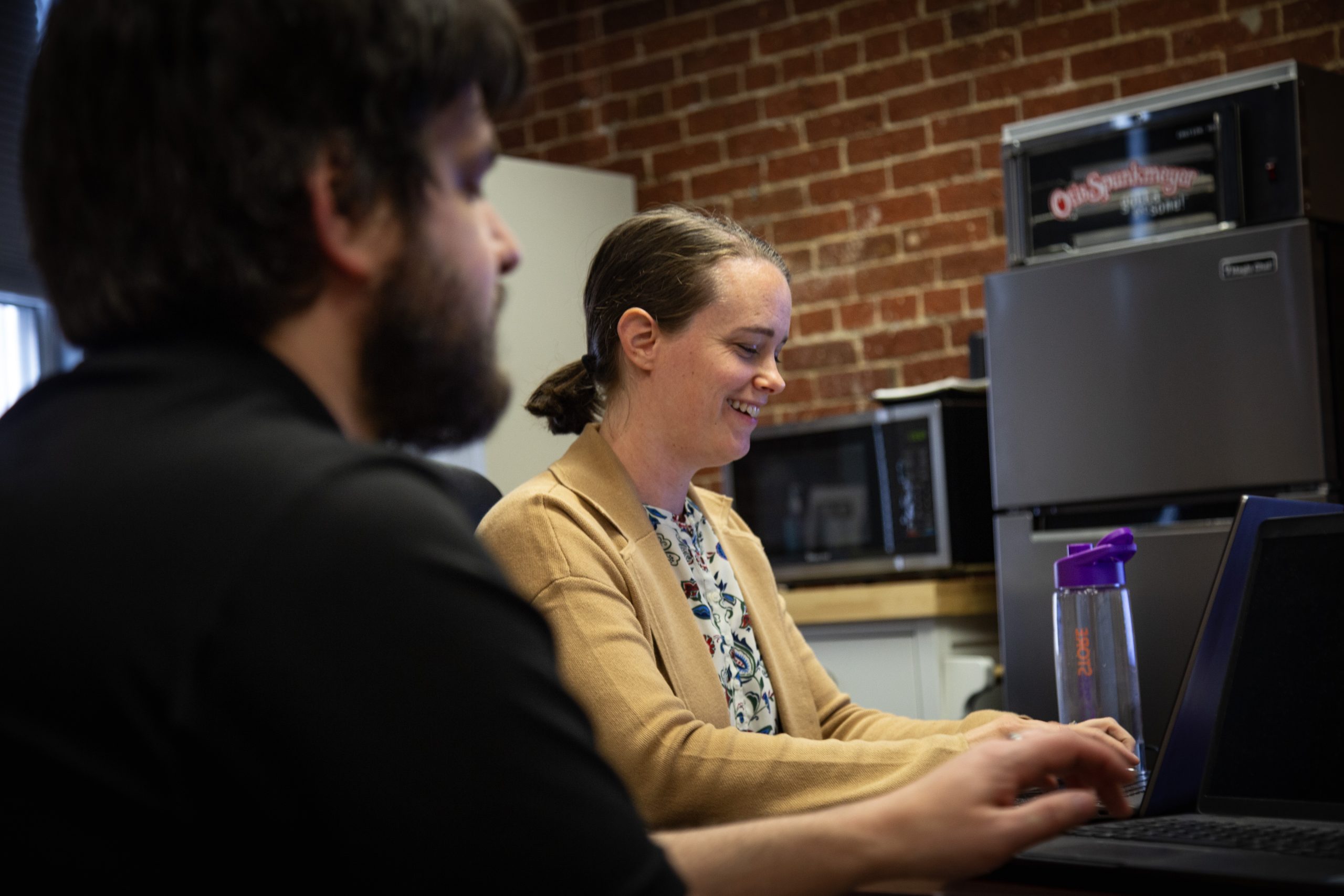 Dovetail Employees Erin and Dave working on computer.